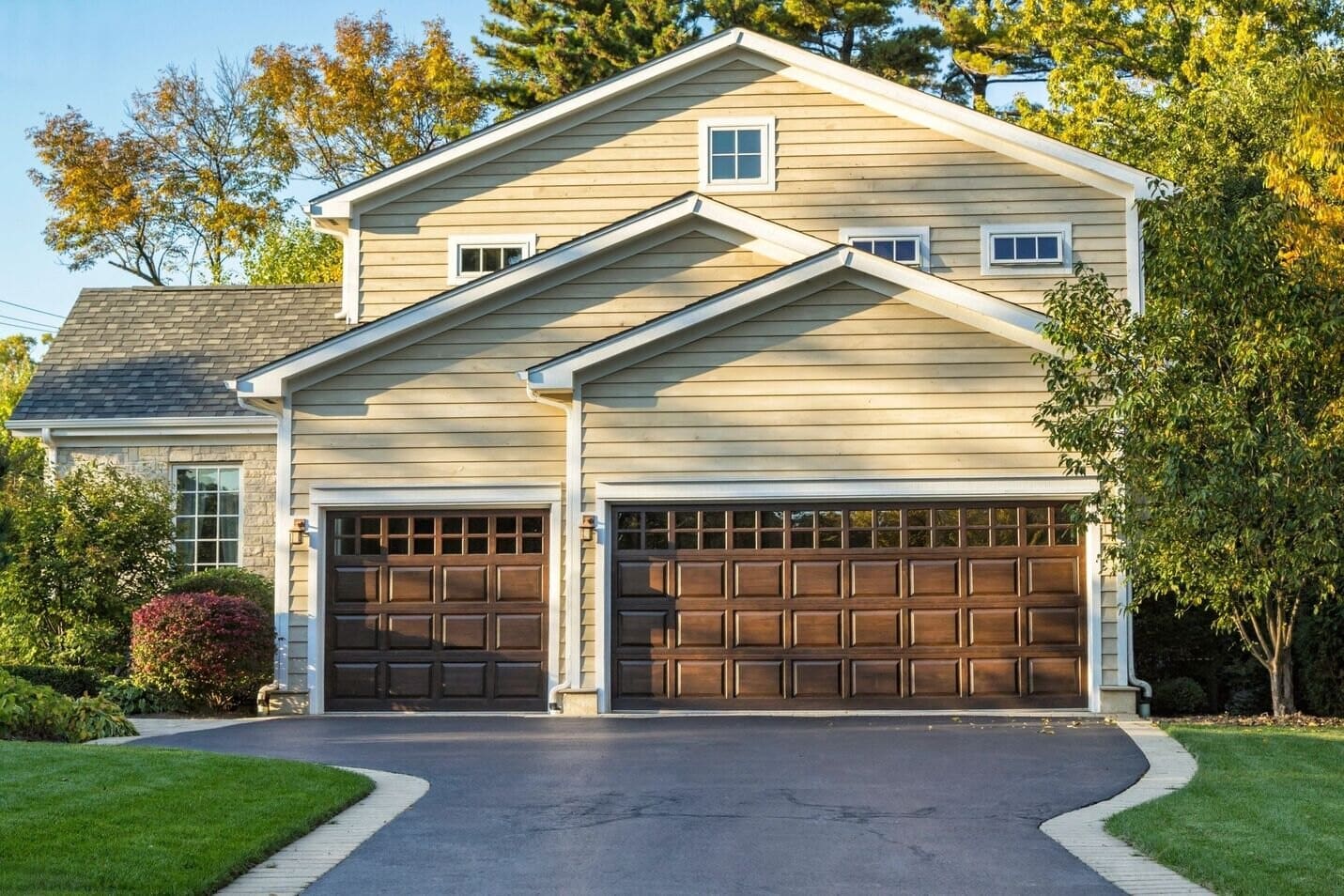 A large garage with two doors and a driveway.