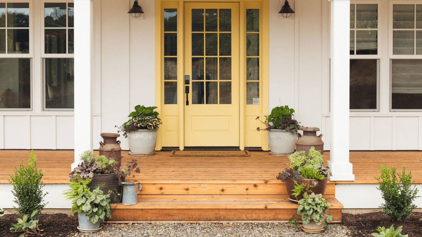 A yellow door and steps leading to the front porch.