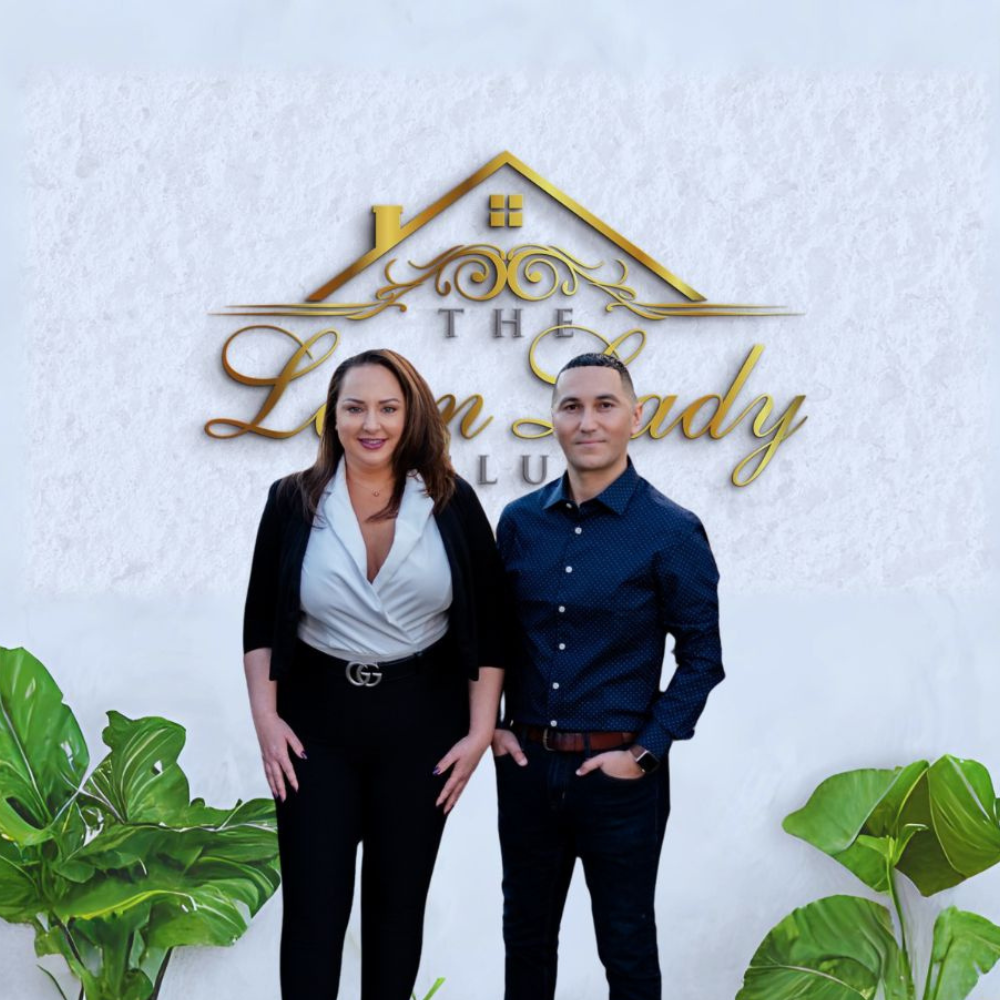 A man and woman standing in front of a sign.